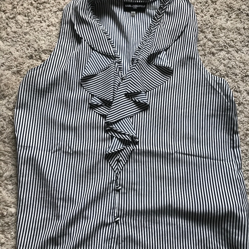 Black and white sleeveless ruffle front top.